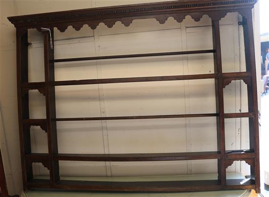 A mid 18th century oak plate rack W.163cm